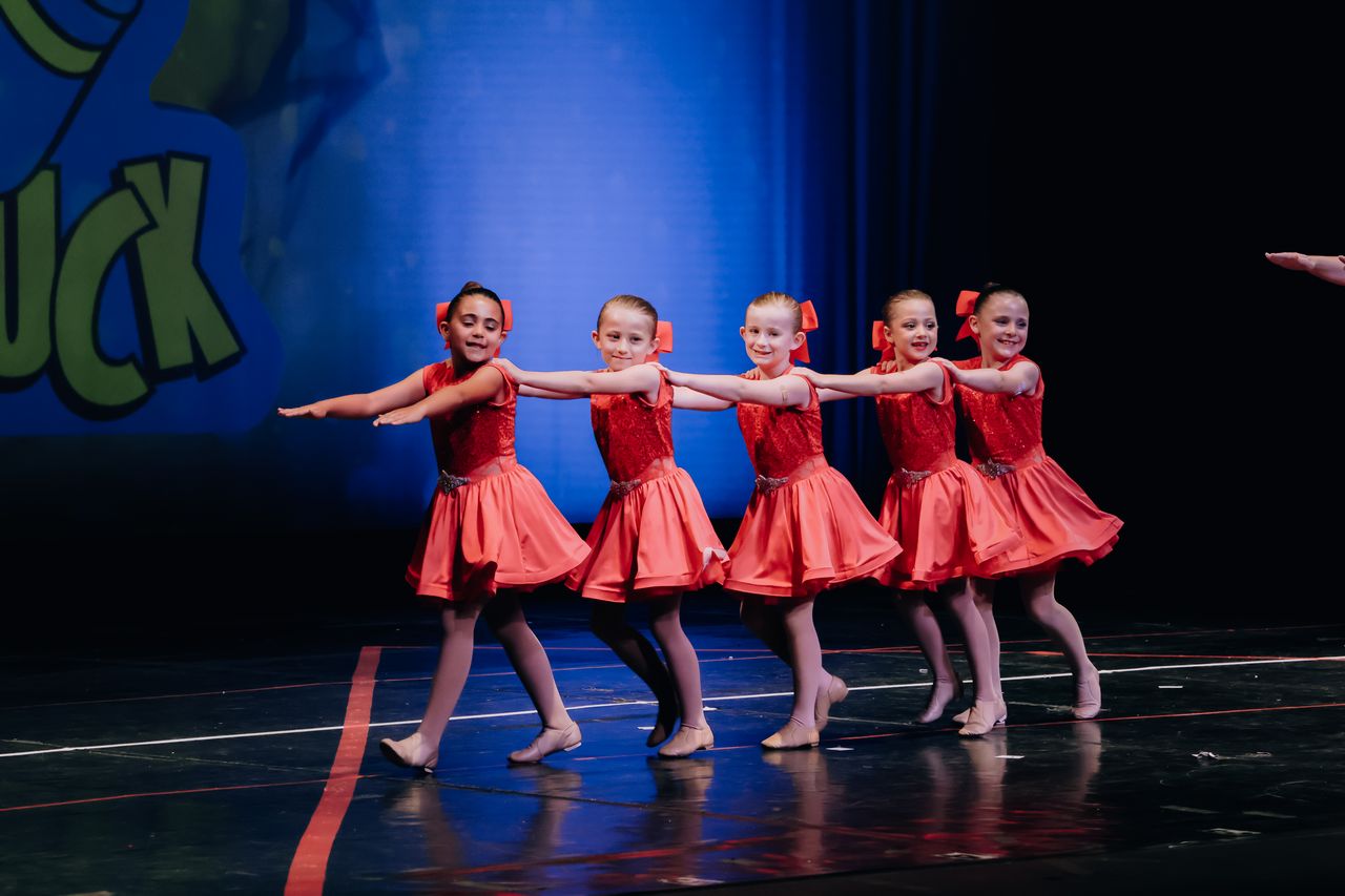 Children performing together in a musical theater production